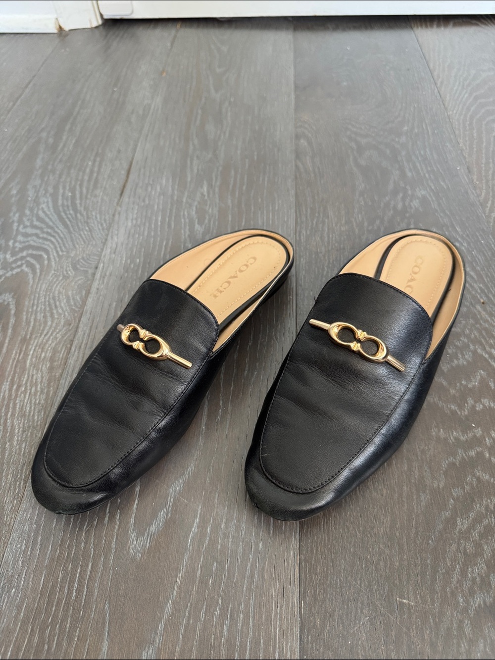 Coach Black Leather Backless Loafers with Gold Chain Accent